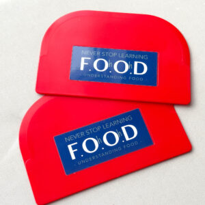 Red plastic dough scraper with dark blue F.Oh.Oh.D logo, pictured on a white background