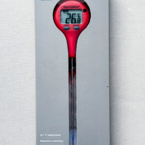 Red plastic thermometer in grey packaging on white background