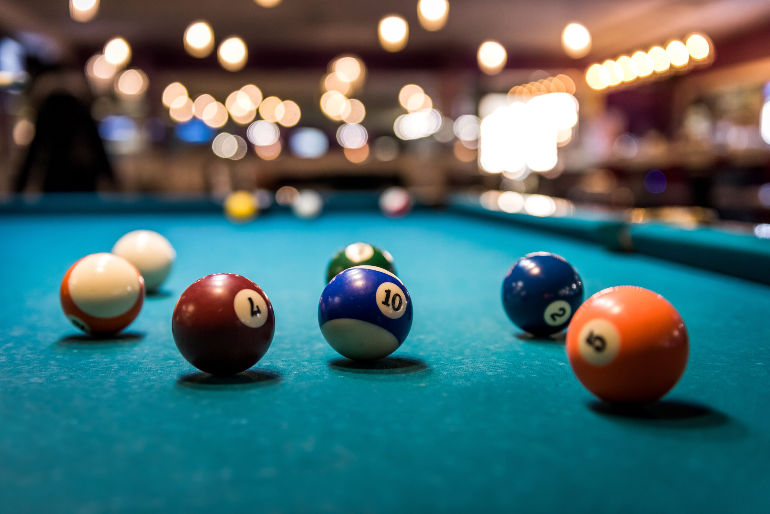 Colorful billiard balls on playing table, dispersed